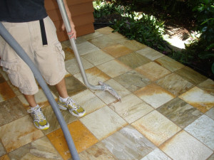A man cleaning a stone floor